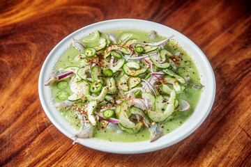 Mexican seafood called aguachile, raw shrimp dipped in lime and green sauce