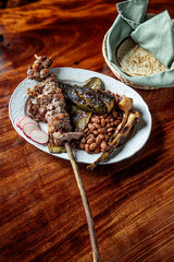 Tasted steak of diezmillo, roasted and juicy cut, accompanied by cambray potatoes, asada, chirmole, pot beans and roasted cactus