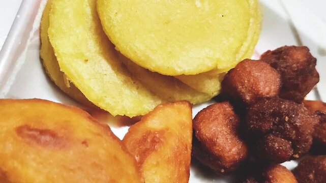 Traditional Bangladeshi Pitha Puli Assortment on Tray &ndash; Sweet and Spicy Homemade Rice Flour Snacks with Coconut, Jaggery, and Palm Juice, Representing Bengali Winter Festival Delicacies