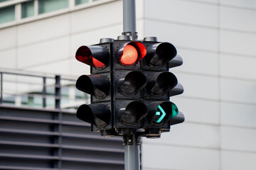 Urban traffic lights showing red and green signals at modern intersection representing intelligent...