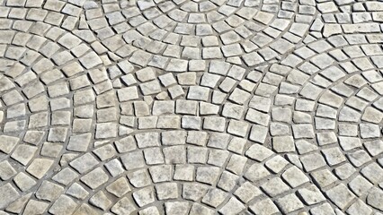 Fototapeta premium Gray curved cobblestone pavement texture background
