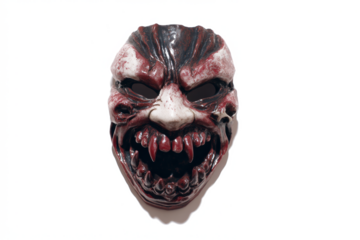 Scary monster mask with sharp teeth and bloody details a creepy costume accessory for Halloween isolated on white