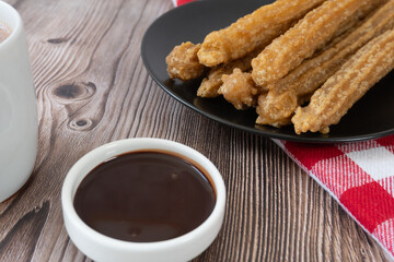 Approach to table with churros and chocolate