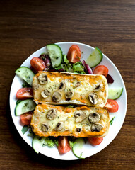 Above Shot of Panini Roll with Pepper Spread, Mushrooms, Cheese and Green Spring Salad,  Vegetarian Healthy Diet Food