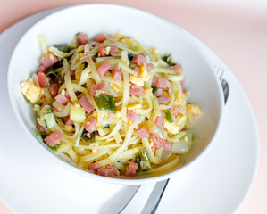 Close-up of Bami Goreng Stir Fry Noodles with Ham, Leek and Egg Omelette, Indonesian Restaurant Food Cuisine