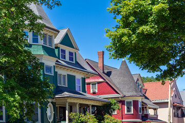 Historic green and red houses with decorative trim and classic architecture in Brighton, Boston, Massachusetts, USA
