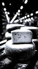 Cheese wheels displayed on wooden shelves in a warehouse setting with soft lighting and a ambiance