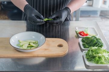The chef lays out the salad. 