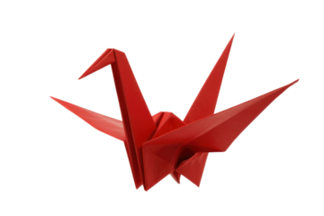 A vibrant red origami crane, a symbol of peace and hope, crafted with precision and artistry. background removed