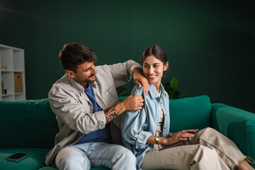 Young couple enjoying relaxing shoulder massage home
