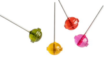 Four colorful lollipops with long sticks float against a transparent background. background removed