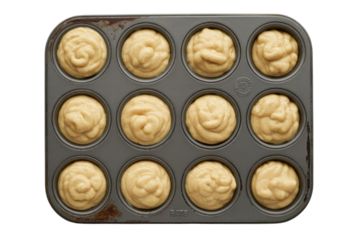 Unbaked muffin batter in a dark gray muffin tin, ready for the oven. background removed