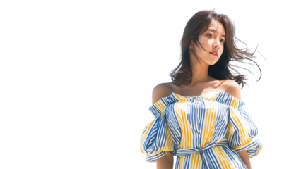 PNG of A young Asian woman in a vibrant striped off-shoulder dress, enjoying the warm sunshine with a carefree expression.