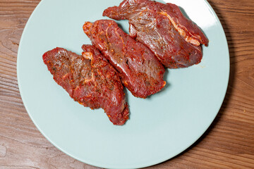 Close-Up of Marinated Raw Steak on a Plate
