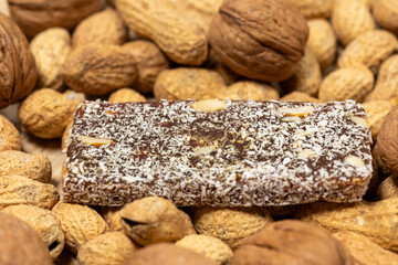 Close-Up of a Coconut Protein Bar with Peanuts and Walnuts
