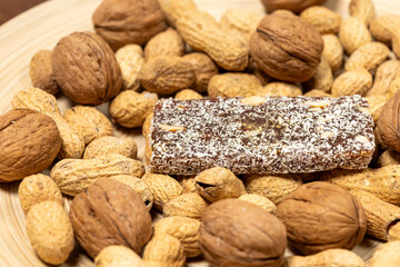 Close-Up of a Coconut Protein Bar with Peanuts and Walnuts
