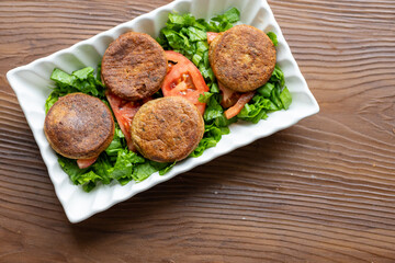 Close-Up of Kotlety Mielone Meatballs with Greens on a White Plate
