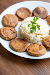 Close-Up of Kotlety Mielone Meatballs with Greens on a White Plate
