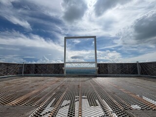 Window frame with cloudy blue sky in background
