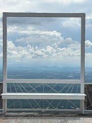 The window frame with cloudy sky in background