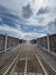 The walkway to window frame with cloudy sky in background