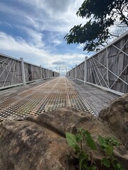 The walkway to window frame with cloudy sky in background