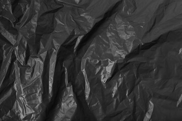 Abstract wrinkled black crumpled plastic texture background
