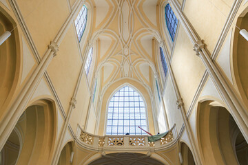 Elegant gothic cathedral interior featuring majestic arched ceiling and stained glass windows
