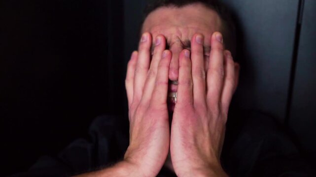 Close up portrait of young man scream and yell from headache and pain. Suffer from depression and bad mood. Broken guy, angry and mad. Crisis and unhappiness.