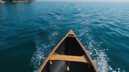 Obraz premium Serene View from a Canoe Slicing Through Calm Waters Beneath a Clear Blue Sky
