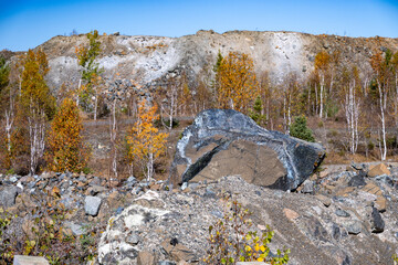 An asbestos rock in a mine waste field