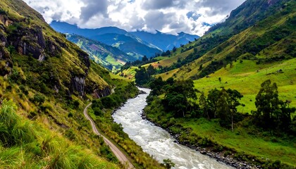 Fototapeta premium A winding river flows through lush valleys nestled between dramatic mountain ranges, showcasing a vibrant tapestry of green landscapes.