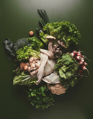 Fresh vegetables on dark green surface showcasing vibrant colors and textures in natural setting