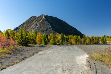 A mountain of asbestos wastes in the fall colors
