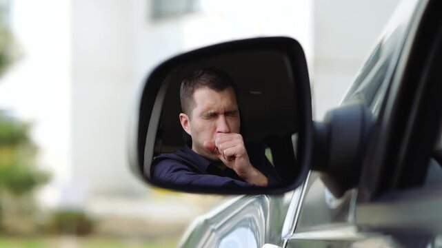 Young man inside car. Start caughing and beating his own chest. Hard to breathe with strong caughing. Sick ill person in car.