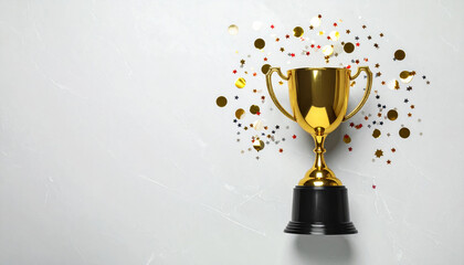 Golden trophy cup with black base surrounded by colorful confetti on light textured background, symbolizing victory and celebration with shiny festive atmosphere