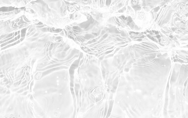 White water with ripples on the surface. Defocus blurred transparent white colored clear calm water surface texture with splashes and bubbles. Water waves with shining pattern texture background.