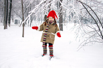 a little girl in an elf costume in the fores