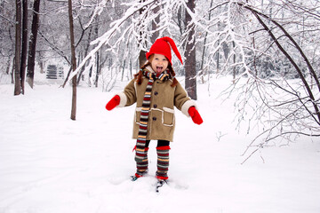 a little girl in an elf costume in the fores