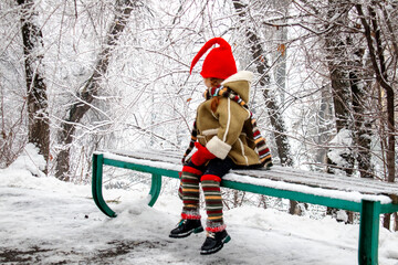a little girl in an elf costume in the fores