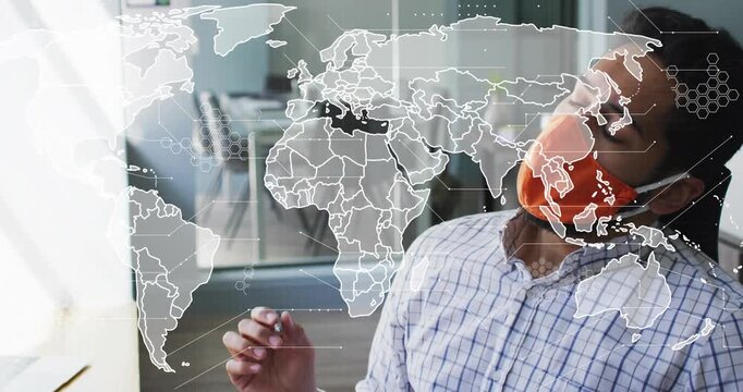 Tech analyst wearing orange mask tapping pen as map overlay shifting then analyzing data on keys