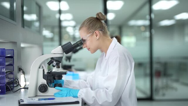 A pathologist performs real-time annotation, looking at a tissue biopsy under the microscope while using a stylus and tablet to digitally circle and document abnormal cells for her report.