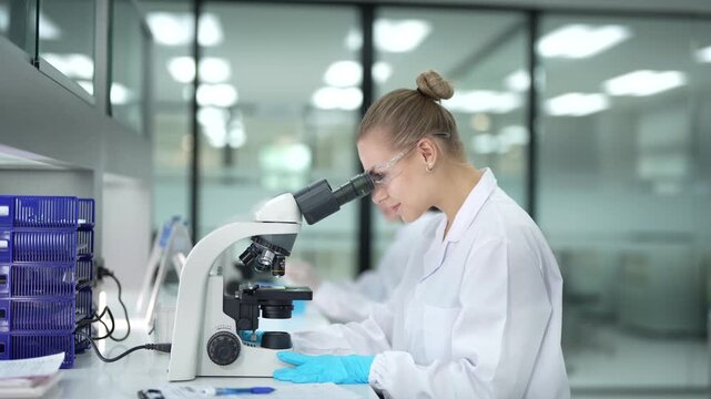 A pathologist performs real-time annotation, looking at a tissue biopsy under the microscope while using a stylus and tablet to digitally circle and document abnormal cells for her report.
