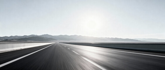 A long empty road under a bright sun with distant mountains in the background, presenting a serene and open landscape.