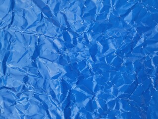 Abstract blue crumpled paper texture background. Copy space 