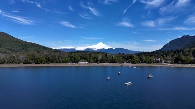 4K Drone Footage Flying Backward Over a Lake Toward Villarrica Volcano