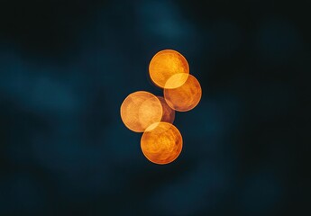 Out-of-focus, orange bokeh lights cluster on dark background