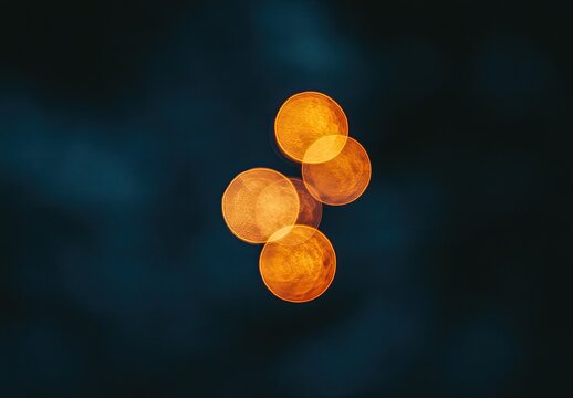 Out-of-focus, orange bokeh lights cluster on dark background