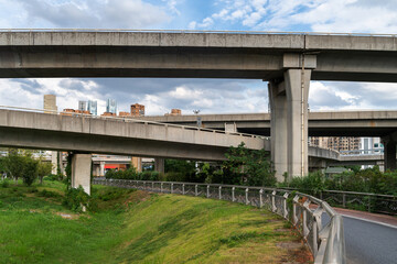 Concrete structure and asphalt road space under the overpass in the city