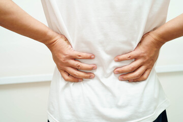 Asian man pain back muscle, spine and bone from accident.